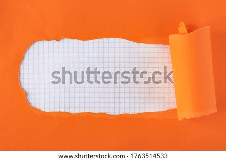 torn orange paper. inside notebook sheet