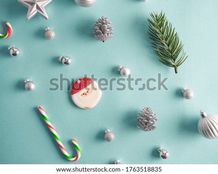 Close-up of christmas decorations against light blue background.