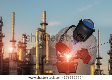 Welding Tig gas process on Oil refinery plant background.