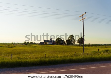 View of a Canadian Farm at sunset from a moving vehicle