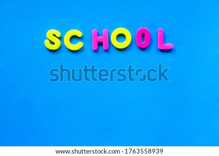 Brigh blue backgroun with the inscription school on trendy neon background. Place for text