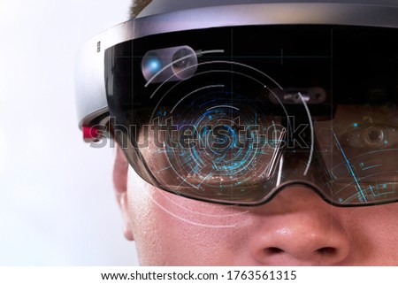 Portrait of man try Mixed reality with HoloLens glasses isolated on white background.  Royalty-Free Stock Photo #1763561315