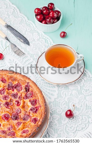 Klafuti cherry pie on wooden background. Klafuti french cherry pie.