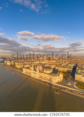 Aerial drone view of Hungarian Parliament by Danube river in Budapest sunset hour