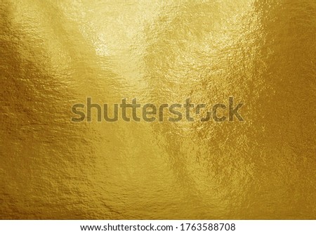 Gold foil texture background with highlights and uneven surface Royalty-Free Stock Photo #1763588708