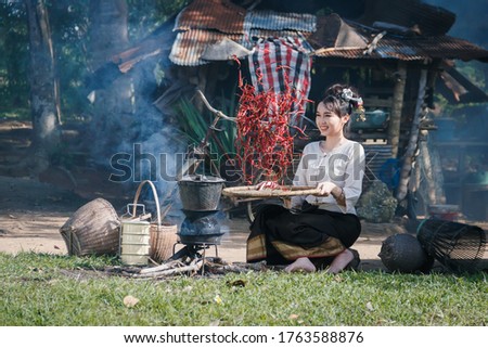 Picture with noise in over light ,Lifestyle of rural Asian women in the field countryside thailand,Asian woman wearing traditional dress working at countryside thailand.