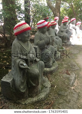 Monk statues wearing red and white bib at Daisho-in Temple on Miyajima Island, Japan.