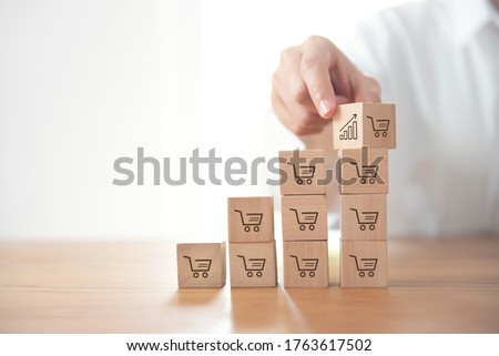 sale volume increase make business grow,  businesswoman flips cube with icon graph and shopping cart symbol. Royalty-Free Stock Photo #1763617502