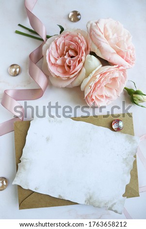postcard mockup. a small bouquet of pink roses and an envelope. wedding invitation. greeting card