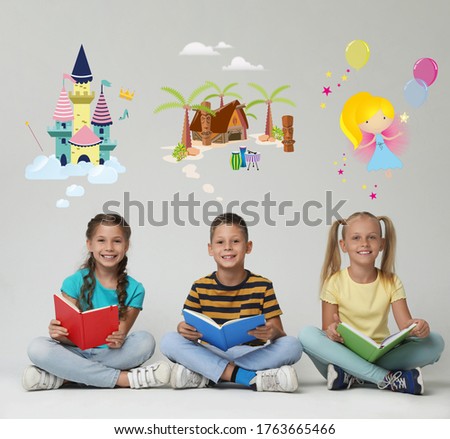 Happy children reading books on grey background