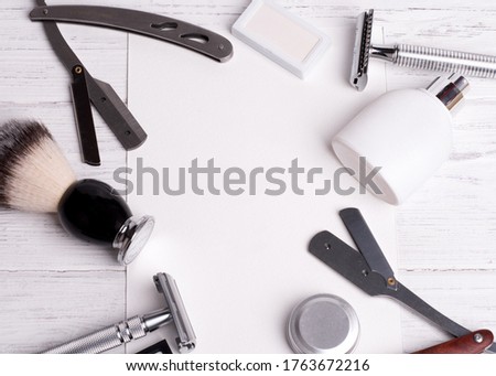 Razors, brush, balsam, blade, perfume  and empty card on a white background.