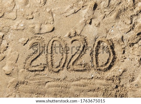Summer vacation 2020. The inscription, the words written, drawn on the sea sand, top view. Photograph, copy space.