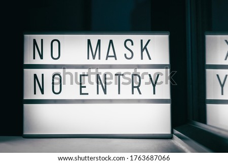 Covid-19 mask obligatory to enter stores . SIGN NO MASK NO ENTRY at storefront window. Face covering wearing mandatory when shopping outside of home. Coronavirus prevention measure.