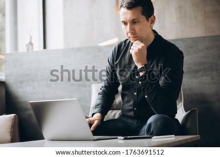Handsome business man working on computer in office