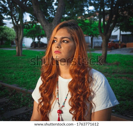 PHOTOGRAPHY YOUNG WOMAN WITH RED HAIR SITTING IN A RAILROAD  