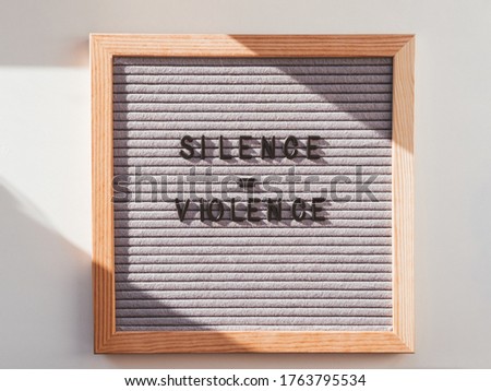 Top view on letter board with words Silence equal Violence. Flat lay concept with actual statement. Social issue. Race problem in society.