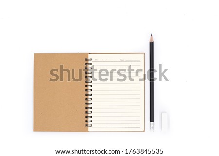 A pencil placed beside the book on a white background