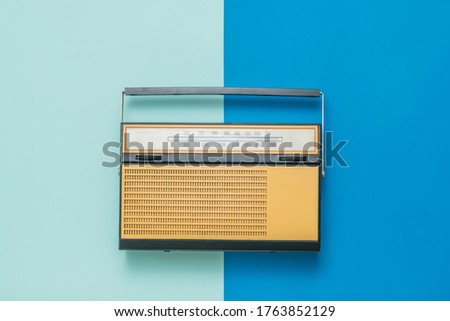 Vintage radio on a blue and light blue background. Radio broadcast live. Vintage technique.