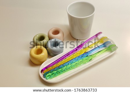 Family toothbrush and cup in the washroom