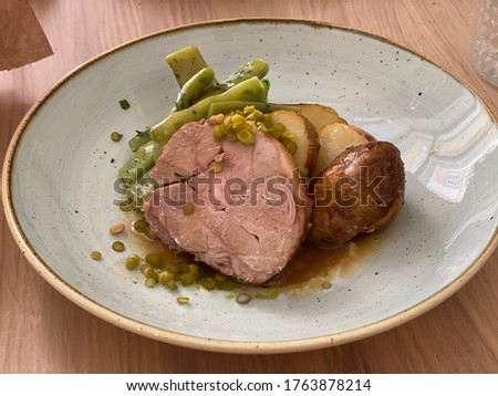Roasted lamb leg with potatoes and pies 