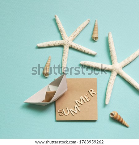 Summer vacation concept. Word 'Summer' with shellfish and starfish on blue background. flat lay, top view, copy space