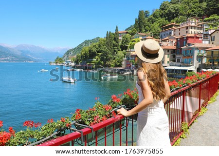 Holidays on Lake Como. Back view of beautiful fashion girl enjoying view of the Walk of Lovers in Varenna, Lake Como. Summer vacation in Italy.