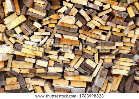 Stack of firewood, Textured of dry chopped logs for wallpaper, Natural wood background for design template.