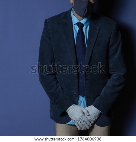 Photo businessman in a sanitary mask and medical gloves, spreads his hands, was left without pants, no money, isolated on background. Business crisis during a pandemic.