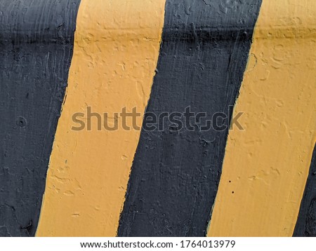 Yellow and black stripes on the concrete surface