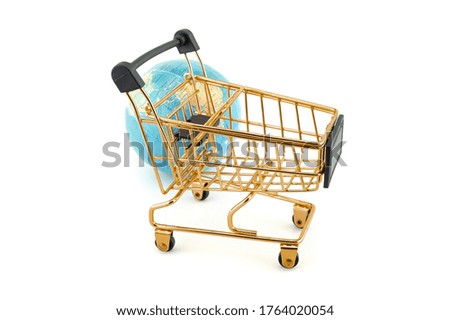 A golden shopping cart and a globe isolated on a white background