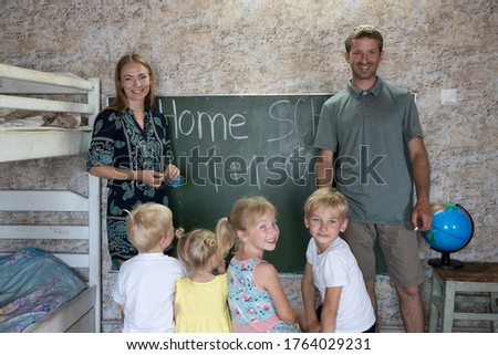 Portrait of a big family at the blackboard at home school.