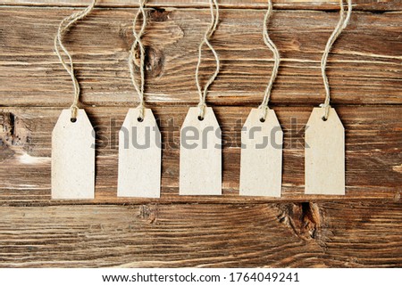 The five card badges with ropes on wooden table.