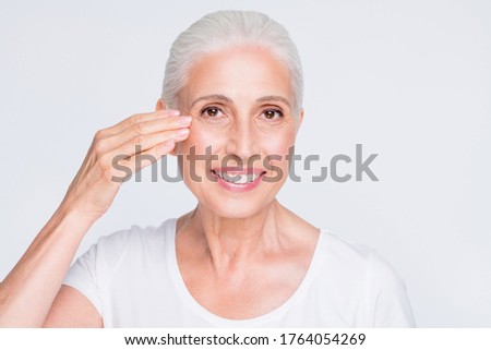 Close-up portrait of her she nice-looking attractive lovely groomed cheerful gray-haired lady touching smoothing perfect skin lifting uplift effect isolated over light white grey pastel background