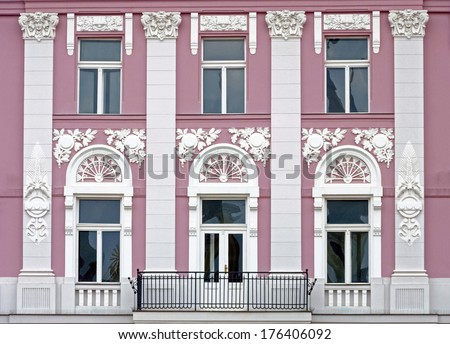 Old urban building stone facade with tall windows in Timisoara, Romania