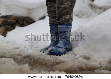 little boy and military patterned shoes.