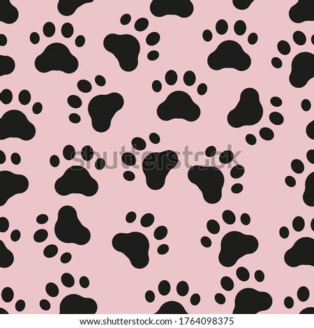 Seamless pattern of animal black paw print on pink background.