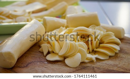 Close up the thinly sliced cassava on a cutting board Royalty-Free Stock Photo #1764111461