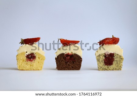 Delicate, fluffy pieces of cupcakes with fruit filling and cream, decorated with strawberries