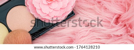 Pink Camellia flower and make up brush on fur trendy background. Professional Make up Brush on pink fur  fabric, closeup banner
