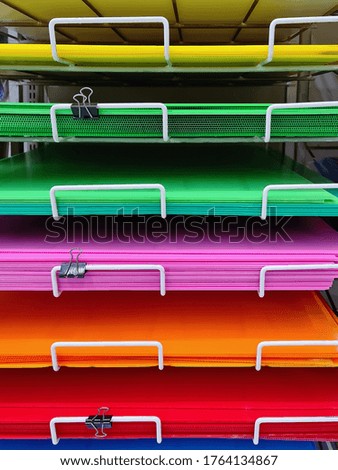 Multi-Level of Colorful Plastic Boards on Shelf