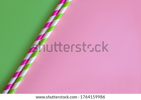 Drinking paper straws on bright background,copy space. Top view of colored paper disposable eco-friendly straws for summer cocktails.biodegradable eco-friendly paper straws. cocktail tubes