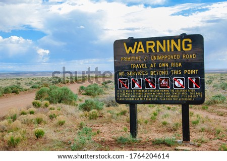 Warning sign declaring absence of services on the unpaved dirt road through the desert to Toroweap point in Grand Canyon national park, Utah, USA Royalty-Free Stock Photo #1764204614