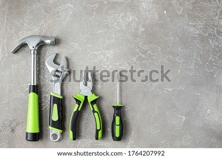 A set of various construction tools. Tools for home repair. Work on a construction site. On a gray, rough concrete background. Flat lay.