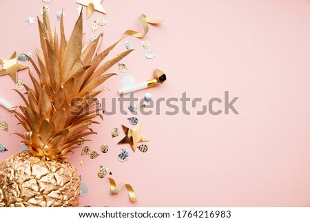 Flat lay tropical pineapple and confetti party celebration background