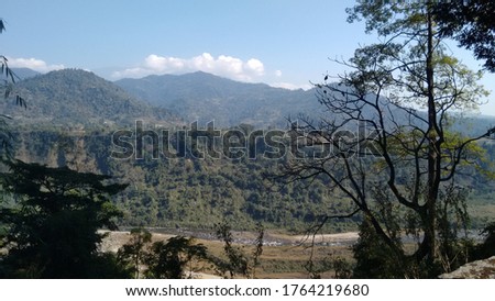 Beautiful morning scenic view of lower Himalayas from North Bengal in India with wild but serene background and natural brook and best place to travel in summer holidays and for photography.