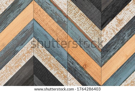 Old multicolored parquet floor. Weathered wooden boards texture. Vintage wooden wall with chevron pattern. 