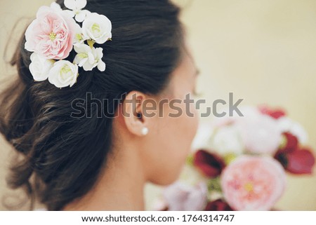 The girl's hair. Flowers in hair. Wedding bouquet.