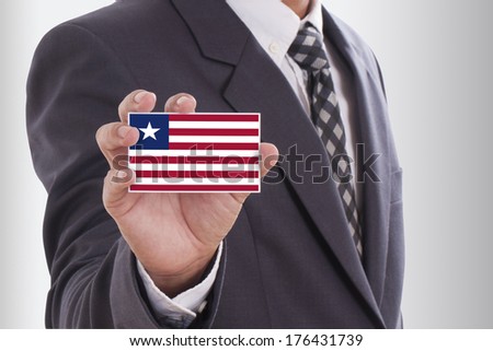 Businessman holding a business card with Liberia Flag 