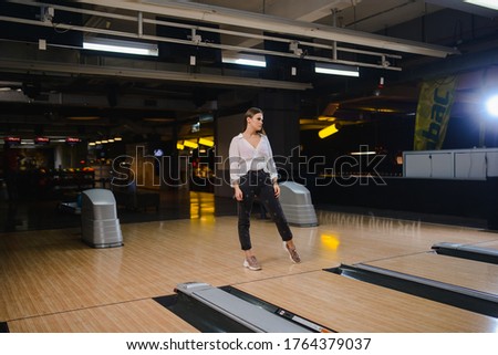 Beautiful caucasian woman on a bowling alley track