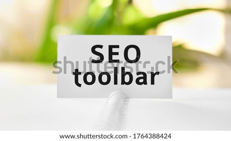 Seo toolbar business seo concept text on a white notebook and green flowers
